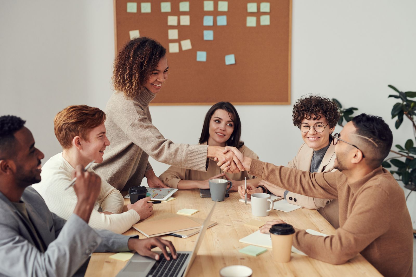 A small agency team shaking hands with a new client